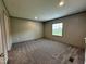 This bedroom boasts neutral walls, and plush carpet flooring at 2232 Tarboro Road Rd, Youngsville, NC 27596