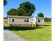 Inviting single-story home with charming front porch, and a lush green lawn at 2232 Tarboro Road Rd, Youngsville, NC 27596