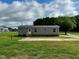 Exterior view of home with lawn and wooded area at 2232 Tarboro Road Rd, Youngsville, NC 27596