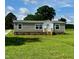 Charming single-story home featuring green lawn, light brown siding, and welcoming front entrance at 2232 Tarboro Road Rd, Youngsville, NC 27596