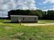 Exterior view of home surrounded by an ample lawn with gravel driveway at 2232 Tarboro Road Rd, Youngsville, NC 27596