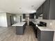 Modern kitchen featuring granite countertops, stainless appliances, and dark cabinetry at 2232 Tarboro Road Rd, Youngsville, NC 27596