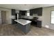 Elegant kitchen with an island, dark cabinetry, and stainless steel appliances at 2232 Tarboro Road Rd, Youngsville, NC 27596