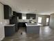 The spacious kitchen includes stainless steel appliances, an island, and ample cabinet space at 2232 Tarboro Road Rd, Youngsville, NC 27596
