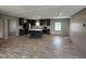 Open-concept kitchen with modern appliances, dark cabinets, and a large island at 2232 Tarboro Road Rd, Youngsville, NC 27596