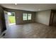 Bright, open living area with natural light, wood floors, and neutral decor at 2232 Tarboro Road Rd, Youngsville, NC 27596