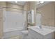 Bright bathroom with white fixtures, including a tub/shower combination and ample vanity storage at 23 Caldwell, Pittsboro, NC 27312