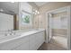 Bathroom featuring double sinks, and a large window offering views and natural light at 23 Caldwell, Pittsboro, NC 27312