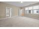 Spacious carpeted bedroom with multiple windows offering natural light and open doorways at 23 Caldwell, Pittsboro, NC 27312