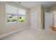 Bedroom with large windows, neutral walls, carpeted floors, and a glimpse of the outdoors at 23 Caldwell, Pittsboro, NC 27312