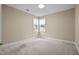 Neutral bedroom featuring wall-to-wall carpet, light walls, and corner windows for natural light at 23 Caldwell, Pittsboro, NC 27312