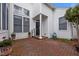 Inviting brick-paved courtyard with a stylish black door and a white column at 23 Caldwell, Pittsboro, NC 27312