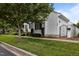 Charming single-story home with white siding, mature trees, and well-maintained landscaping at 23 Caldwell, Pittsboro, NC 27312