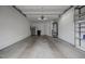 Spacious two car garage with a refrigerator, water heater, overhead storage, and access door at 23 Caldwell, Pittsboro, NC 27312