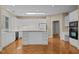 Bright white kitchen featuring modern appliances, an island with storage, and a skylight at 23 Caldwell, Pittsboro, NC 27312