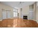 Open-concept living room with fireplace, built-in shelves, and access to the front entrance at 23 Caldwell, Pittsboro, NC 27312