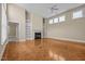 Bright living room featuring built-in shelving, a fireplace, and beautiful parquet wood floors at 23 Caldwell, Pittsboro, NC 27312