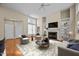 Open-concept living room with high ceilings, a fireplace, and ample natural light at 23 Caldwell, Pittsboro, NC 27312