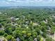 An aerial view of the community nestled among mature trees, with the city skyline in the distance at 2400 Fairview Rd, Raleigh, NC 27608