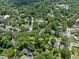 Aerial view showcasing homes at 2400 and 2404 surrounded by lush greenery, providing a peaceful and secluded setting at 2400 Fairview Rd, Raleigh, NC 27608