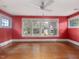 Red bedroom with multiple windows allowing natural light and hardwood floors at 2400 Fairview Rd, Raleigh, NC 27608