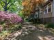 A picturesque exterior view shows a beautiful garden path and lush greenery around the home at 2400 Fairview Rd, Raleigh, NC 27608