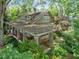 Charming home featuring a covered porch, stone accents, and lush landscaping at 2400 Fairview Rd, Raleigh, NC 27608