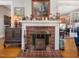 Cozy fireplace featuring a classic mantel, decorative tile work, and adjacent decorative furniture at 2400 Fairview Rd, Raleigh, NC 27608