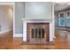 Living room fireplace with red tile surround and white mantel, set on hardwood floors at 2400 Fairview Rd, Raleigh, NC 27608