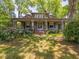Traditional home featuring a brick walkway, covered porch, and mature landscaping for a classic look at 2400 Fairview Rd, Raleigh, NC 27608