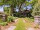 Beautiful home with a long driveway framed by stone pillars and abundant greenery creating a private retreat at 2400 Fairview Rd, Raleigh, NC 27608