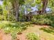 Lovely home surrounded by mature trees and colorful flowerbeds enhancing the property's natural beauty at 2400 Fairview Rd, Raleigh, NC 27608