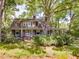 Charming craftsman home with mature trees and a lush, landscaped front yard at 2400 Fairview Rd, Raleigh, NC 27608