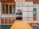 Gourmet kitchen showcasing custom cabinetry, stainless ovens and a butcher block island at 2400 Fairview Rd, Raleigh, NC 27608
