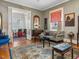 Open living room with hardwood floors, classic furniture, and a seamless flow to other rooms at 2400 Fairview Rd, Raleigh, NC 27608