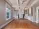 Large living room featuring wood floors, a fireplace, custom shelving, and coffered ceilings at 2400 Fairview Rd, Raleigh, NC 27608