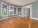 Sunlit living room with bay windows, hardwood floors and glass paneled doors at 2400 Fairview Rd, Raleigh, NC 27608