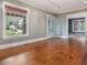 Bright living room with hardwood floors, large windows and fresh neutral paint at 2400 Fairview Rd, Raleigh, NC 27608