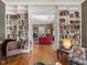 Spacious living room with built-in bookshelves, hardwood floors, and seamless flow to other rooms at 2400 Fairview Rd, Raleigh, NC 27608