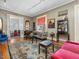 Open living room with hardwood floors, a patterned rug, and elegant, decorative furnishings at 2400 Fairview Rd, Raleigh, NC 27608