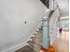 Staircase featuring carpeted steps, a painted banister, and views of the hardwood floor landing at 2400 Fairview Rd, Raleigh, NC 27608