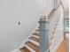 Classic staircase featuring hardwood steps, white risers, and a painted banister at 2400 Fairview Rd, Raleigh, NC 27608