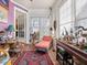 Comfortable sun room with brick floors, large windows, and unique decor, perfect for relaxation at 2400 Fairview Rd, Raleigh, NC 27608
