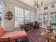 Cozy sun room filled with natural light, featuring a comfortable chaise lounge and vintage decor at 2400 Fairview Rd, Raleigh, NC 27608