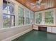 Bright sunroom featuring lots of natural light, a wood ceiling, and built-in cabinets at 2400 Fairview Rd, Raleigh, NC 27608