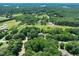 Aerial view of estate surrounded by greenery and nearby bodies of water at 2401 Worthing Ct, Wake Forest, NC 27587