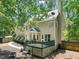 Rear exterior view with a green deck and landscaped backyard area at 2401 Worthing Ct, Wake Forest, NC 27587