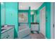 Bright bathroom with turquoise walls, a jacuzzi tub, and dual sink vanity at 2401 Worthing Ct, Wake Forest, NC 27587
