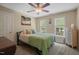 Neutral bedroom with large bed, ceiling fan, and two windows offering natural light at 2401 Worthing Ct, Wake Forest, NC 27587
