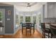 Cozy breakfast nook with bay windows offering wooded views and a modern ceiling fan at 2401 Worthing Ct, Wake Forest, NC 27587